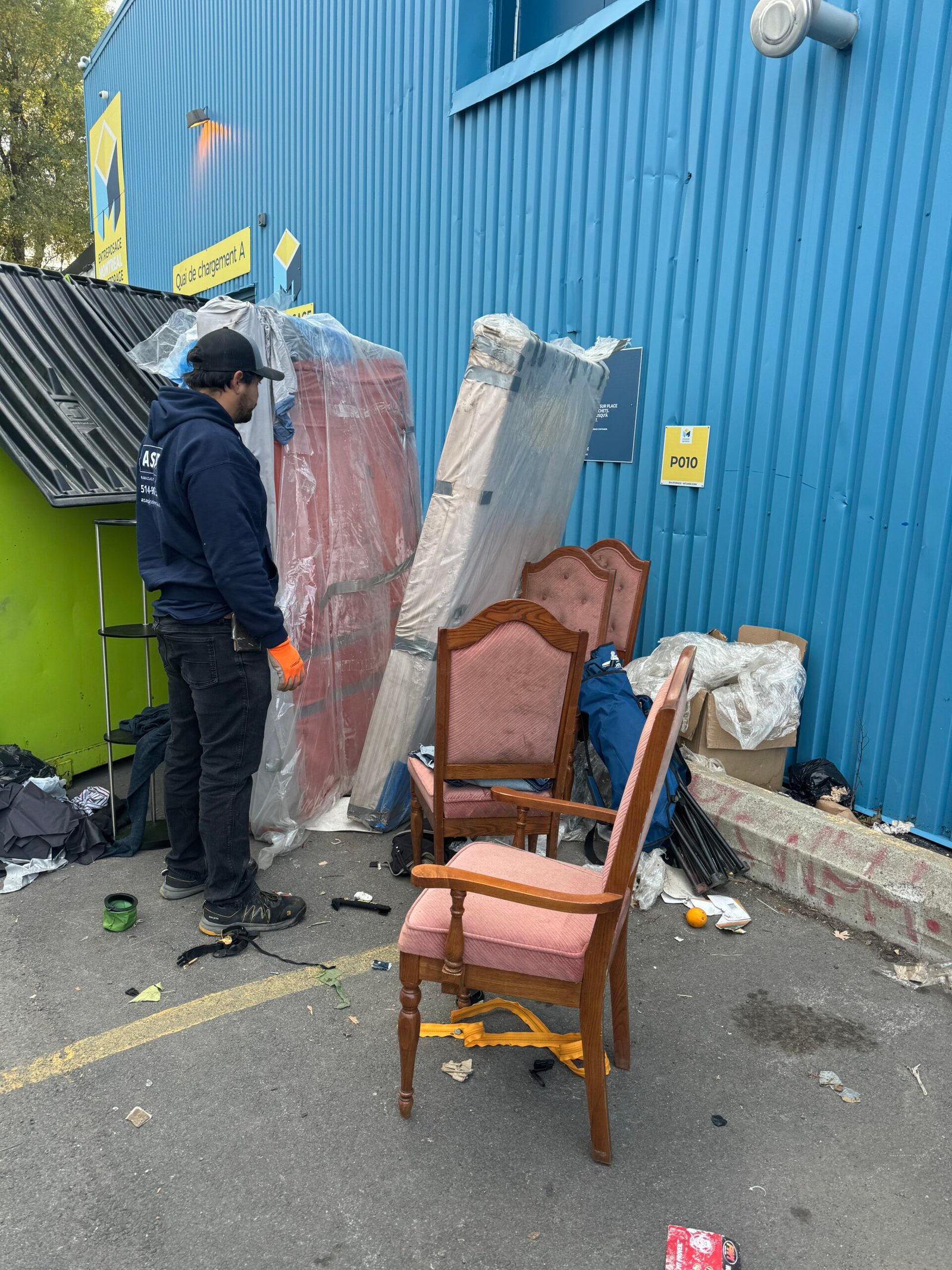 ASAP crew member next to chairs and furniture ready for pickup
