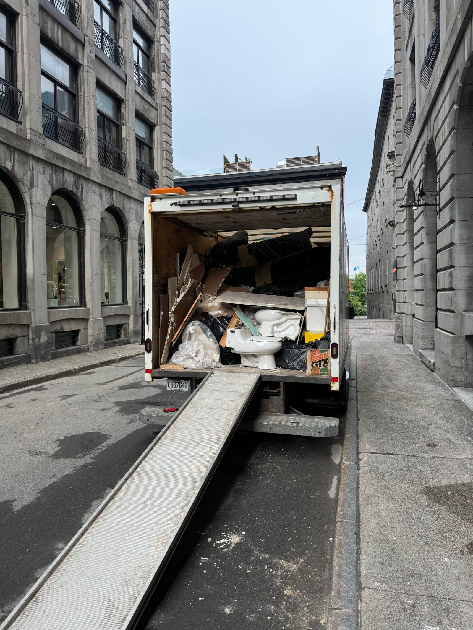 ASAP truck with its ramp down loading items on a Montreal street