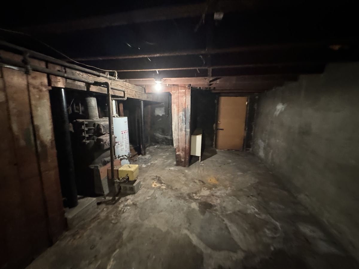 Empty basement floor after the junk was cleared out