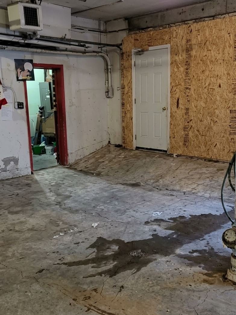Cleared basement with a swept concrete floor