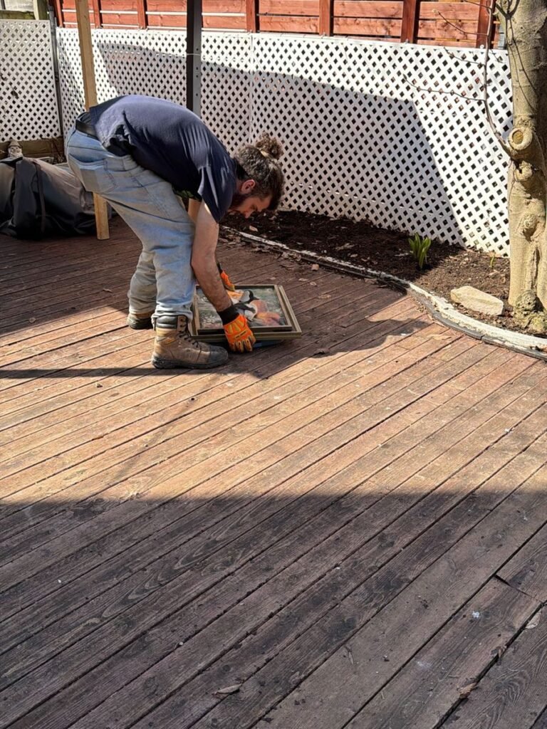 ASAP crew member taking apart an old wooden deck