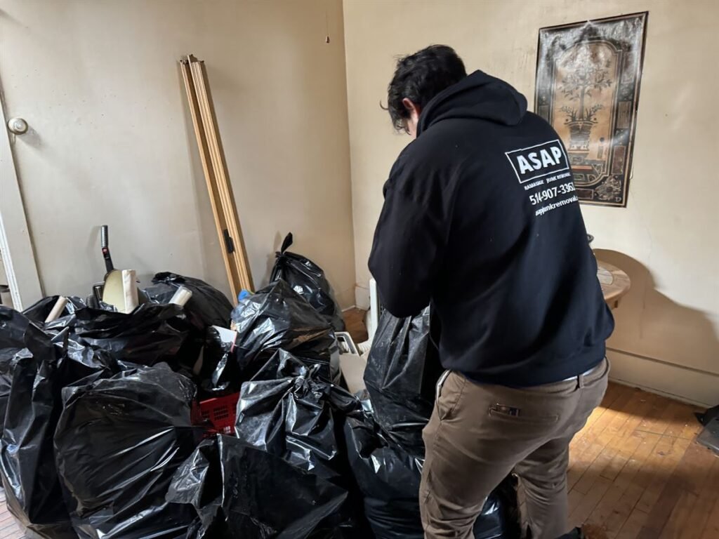ASAP crew member bagging items during an apartment cleanout