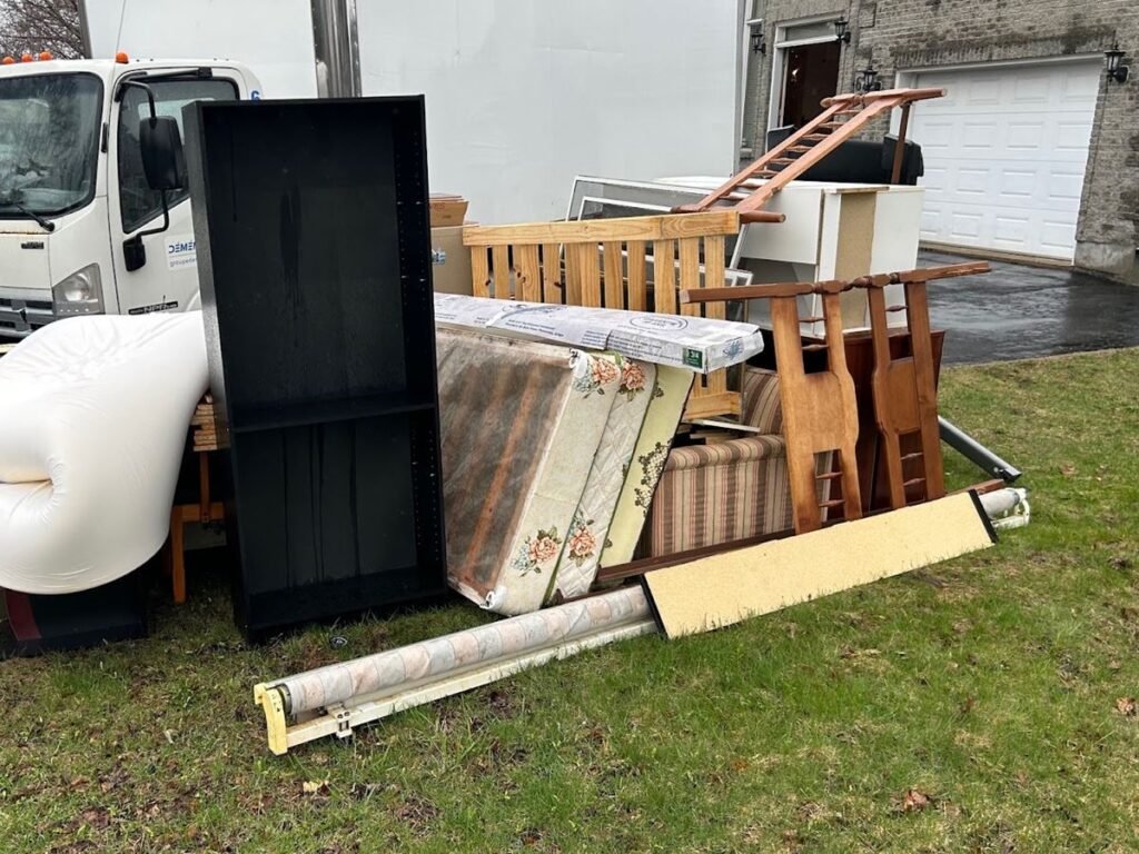 Furniture and mattresses from a cleanout staged beside the ASAP truck