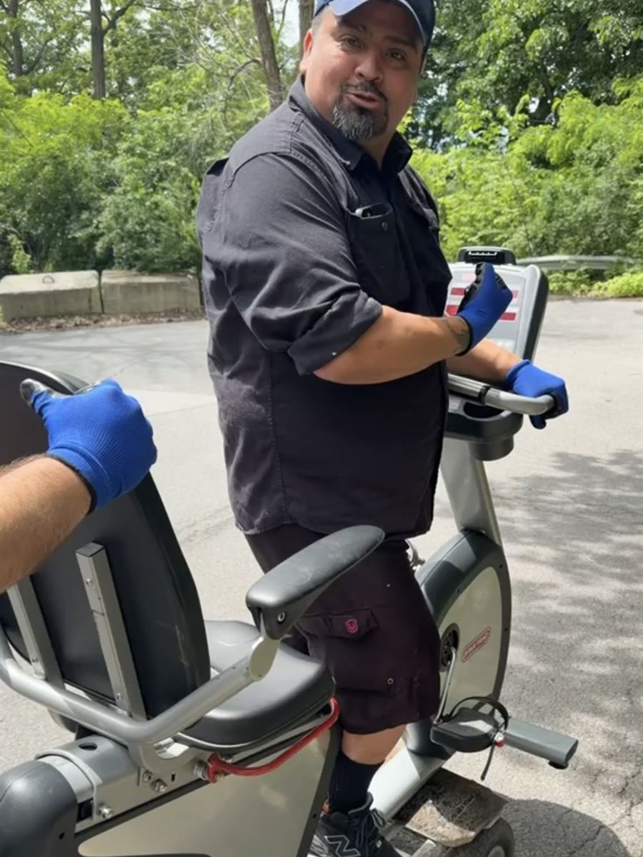 ASAP crew member wheeling out a recumbent exercise bike