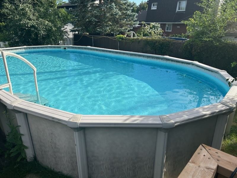 Above-ground pool in a backyard before removal