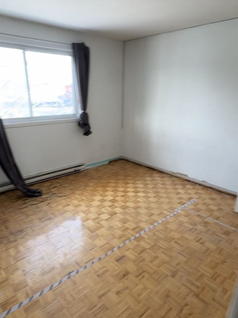 Empty apartment room with clean parquet floor after the cleanout
