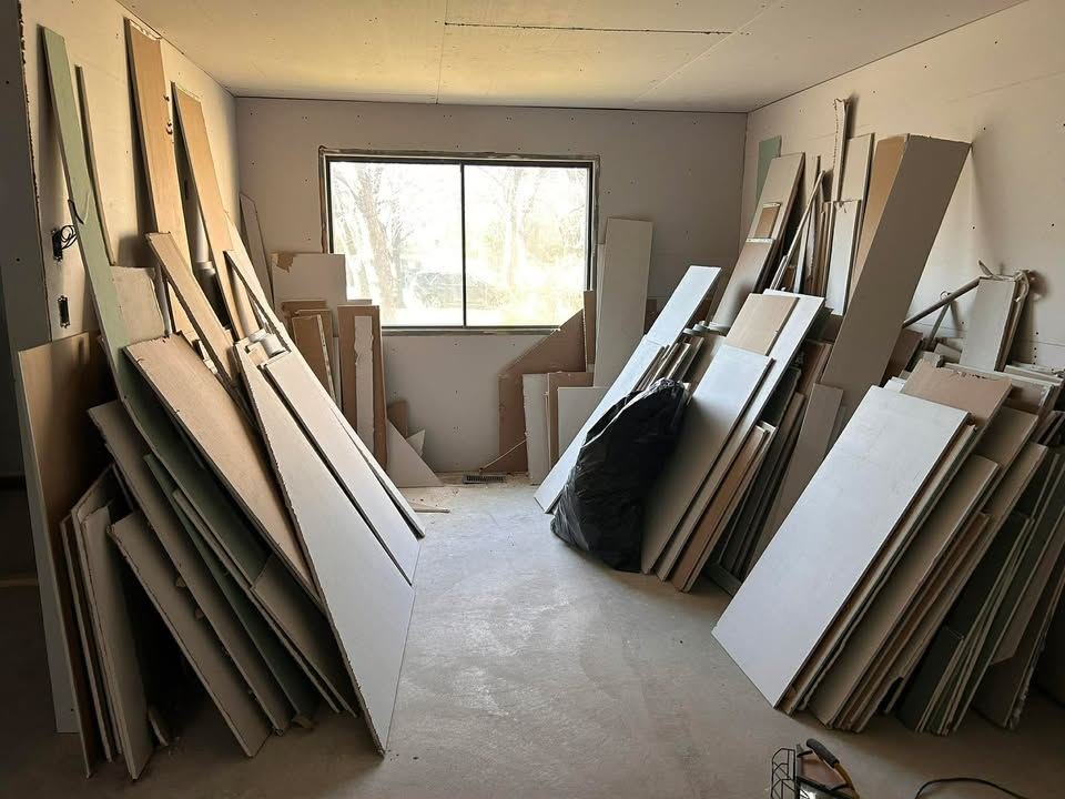 Old drywall sheets stacked in a room after a renovation