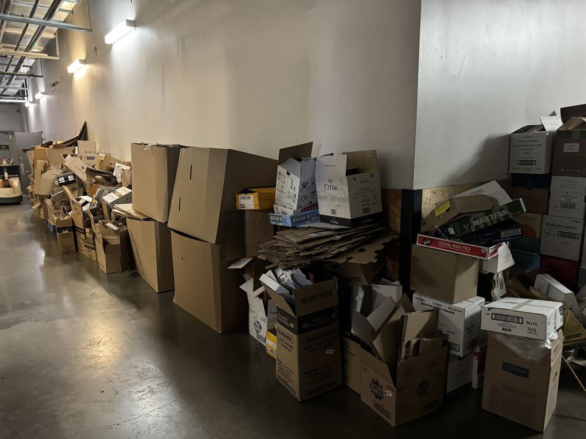 Cardboard boxes and stock piled in a warehouse corridor