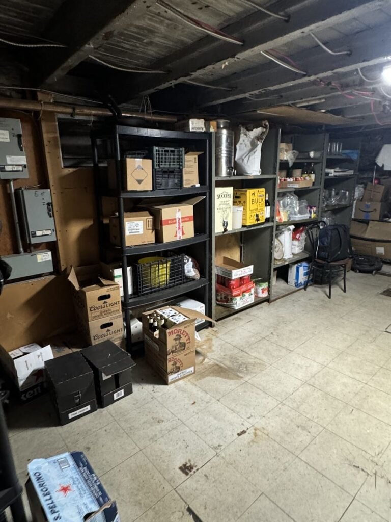 Storage room shelving full of boxes before a cleanout
