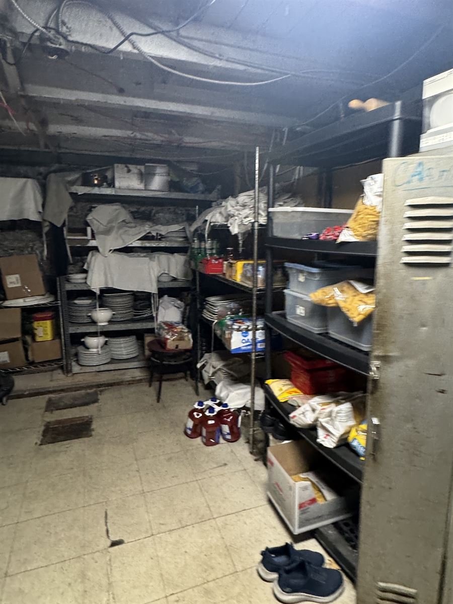 Back storage room with shelves of supplies to clear out