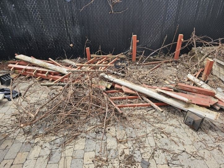 Pile of branches and old wood on a backyard patio